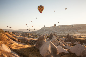 Fototapeta na wymiar Early morning balloon tourist spectacle in Cappadocia, Turkey