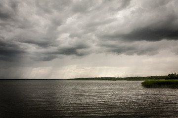 Bad dark weather with clouds and rain on a lake in Masuria, Poland