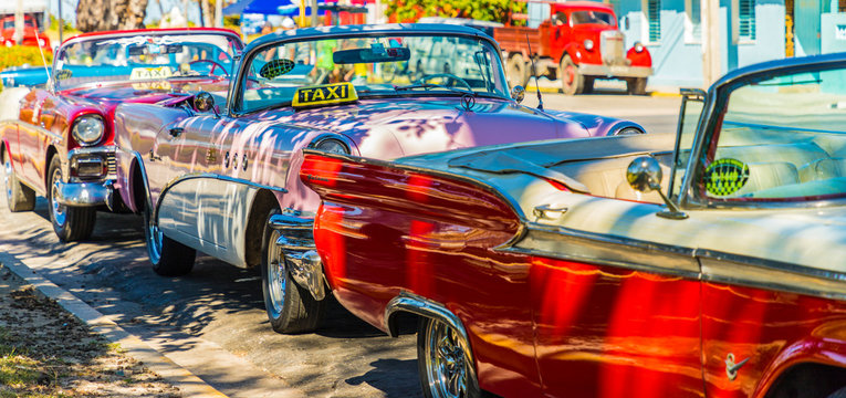 A Row Of Classic American Cars Used As Taxis In Varadero, Cuba
