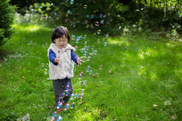 baby girl play bubble at Spring garden