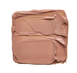 Light beige smear of creamy foundation isolated on white