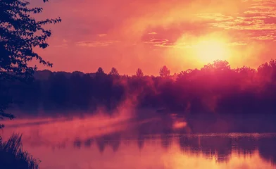 Gordijnen wonderful misty evening. majestic golden sunset over the foggy lake © jenyateua
