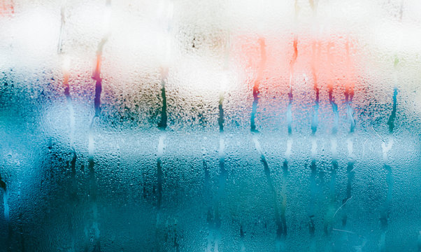 Water drops on blue glass, background photo of increased condensation, horizontal view, high quality