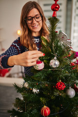 Woman preparing shiny decoration for Christmas / New Year's eve.