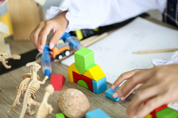 Parent and little child having fun playing educational toys,Family concept.