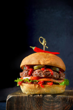 spicy Burger with chili on dark background
