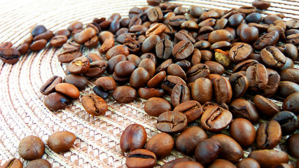 Roasted brown coffee beans on cloth background