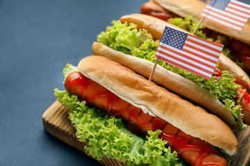Tasty hot dogs with American flags on board