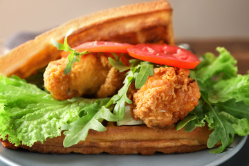 Plate with delicious waffles and chicken, closeup