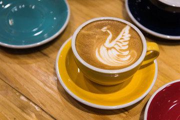 Latte art coffee on wooden table