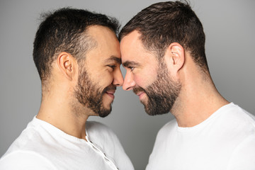homosexual couple over a white background on studio