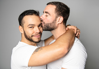 homosexual couple over a white background on studio