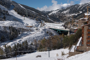 Fototapeta na wymiar Beautiful landscape of Soldeu, Canillo, Andorra on an autumn morning in its first snowfall of the season. You can see almost completed the works of the track of the ski world cup of 2019.