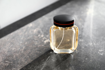 Bottle of perfume on grey table