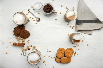 Fototapeta na wymiar Composition with glasses of tasty aromatic coffee and cookies on white background
