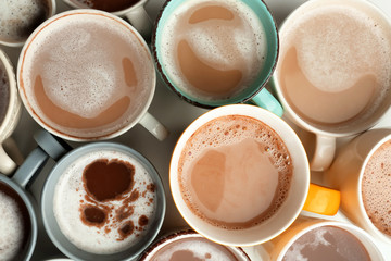 Obraz na płótnie Canvas Many cups with tasty aromatic coffee on white table, top view