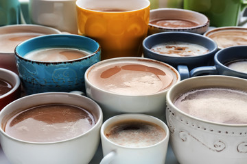 Many cups with tasty aromatic coffee on table, closeup