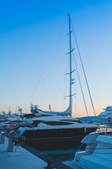 Fototapeta premium Boats and yachts moored in Adriatic port on background of mountains and sunset.