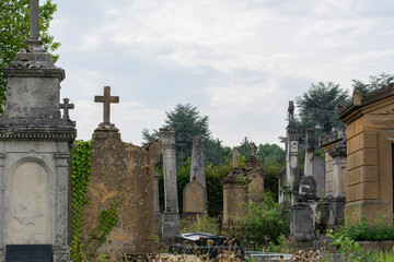 Old french cemetery in the summer day with tombes and crosses