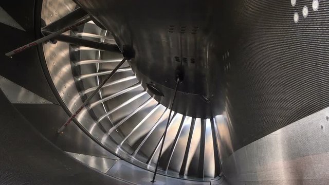 Blades of jet engine from backside moving with wind.