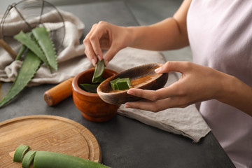 Woman making organic cosmetics with aloe. Health care concept
