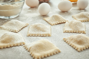 Tasty raw ravioli on table