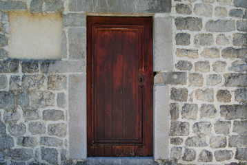 Old wooden door, arched stone wall.Rustic and retro style.