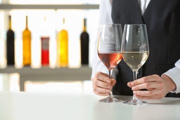 Waiter with glasses of different wine at party