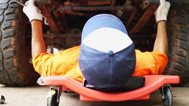 Technicians are working by doing a preliminary inspection of wheel system footage slow motion