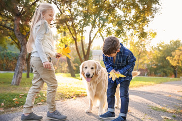 Cute children with dog in autumn park