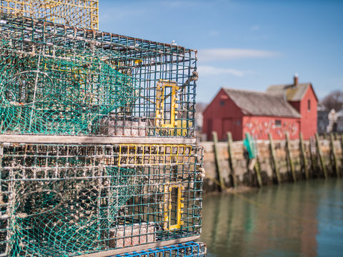 lobster traps with red fishing shack in background