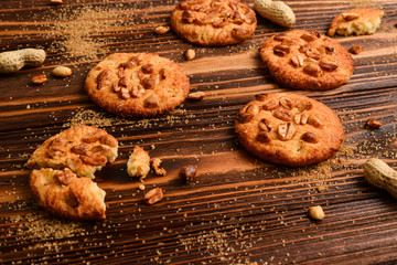 Peanut cookies on wooden table with sugar.