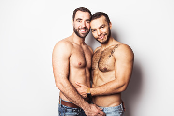 Naklejka premium Young homosexuals gay couple love each other on a white background.