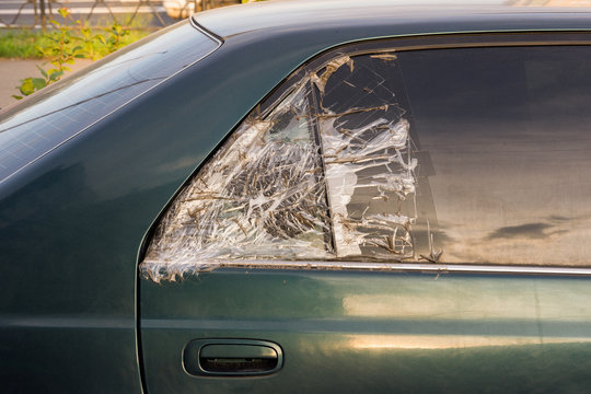 Broken Dark Car Rear Window Sealed With Scotch Tape