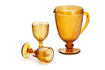 Set of amber glass jug and goblets isolated on white background