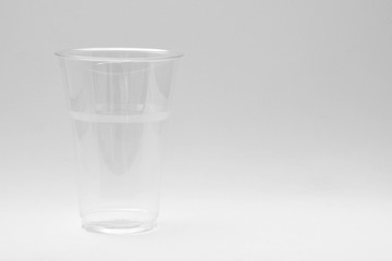 plastic water glass on pale grey background