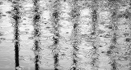 raindrops on floor with reflection from metal cage at the jail