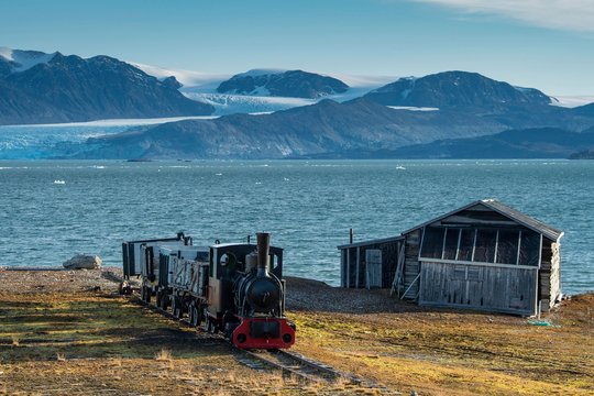Historic mine train in front of the Kongsfjorden, Ny-Alesund, Spitsbergen, Svalbard Islands, Svalbard and Jan Mayen, Norway, Europe