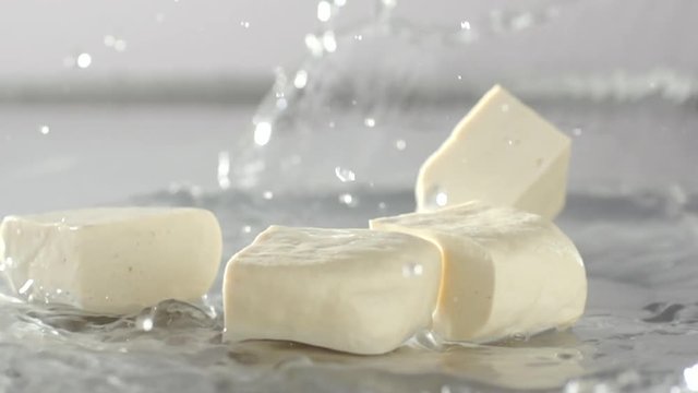 Tofu falling and water splash out,  Cooking food