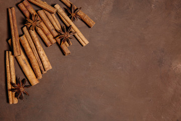 Traditional Christmas spices - Star anise with cinnamon and cloves on dark rustic wooden background