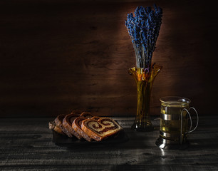 Still life with hot tea, sponge cake and lavender, vintage look. Home interior decor
