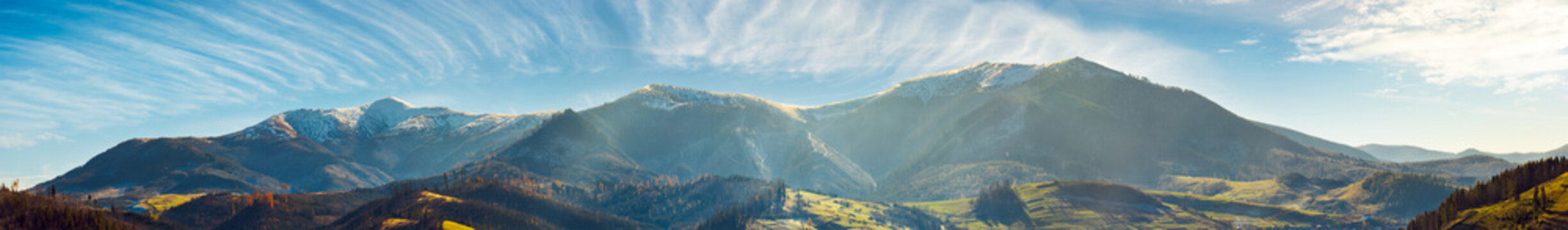 panorama of mountain ridge with snowy tops above the rural valley. wonderful weather condition of november
