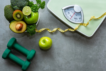 Diet and Healthy life Concept. Green apple and Weight scale measure tap with fresh vegetable and sport equipment for women diet slimming