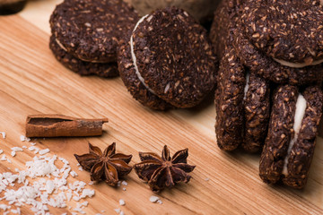 Chocolate cookies on a wooden table. Cookies close-up. Cinnamon, bergamot, coconut.