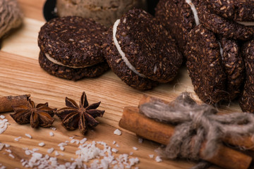 Chocolate cookies on a wooden table. Cookies close-up. Cinnamon, bergamot, coconut.