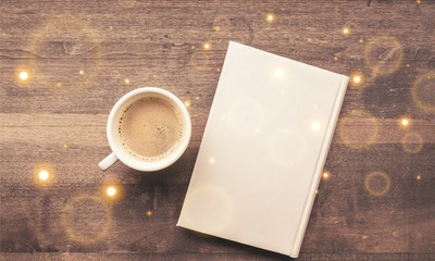 Cup of hot coffee with notebook on