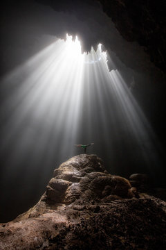 Light rays shining into the Goa Jomblang cave in East Java, Indonesia