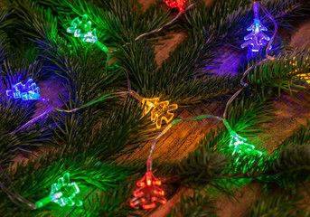 Obraz na płótnie Canvas Background Christmas decoration-christmas lights with decoration on a wooden background