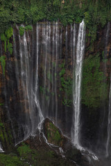 Water flows from every spot along this cliff wall at Coban Sewu in East Java, Indonesia