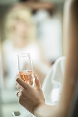 woman holding glass of champagne